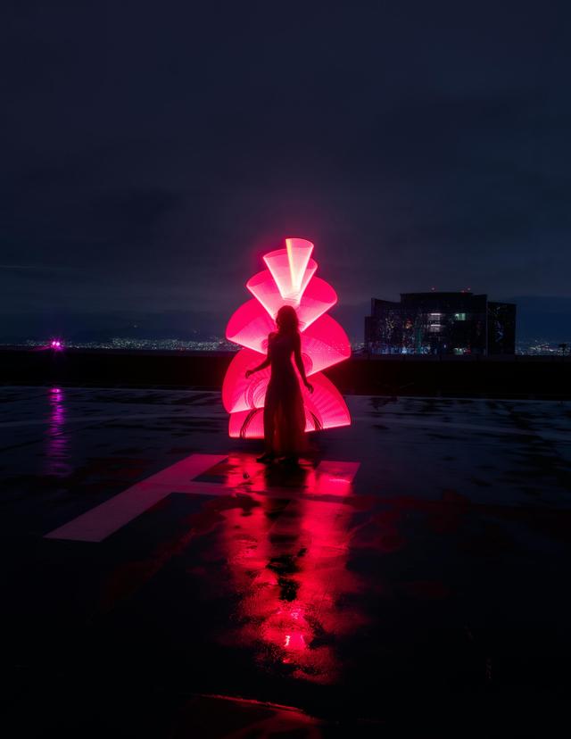 Woman Posing on a Landing Pad at Night 