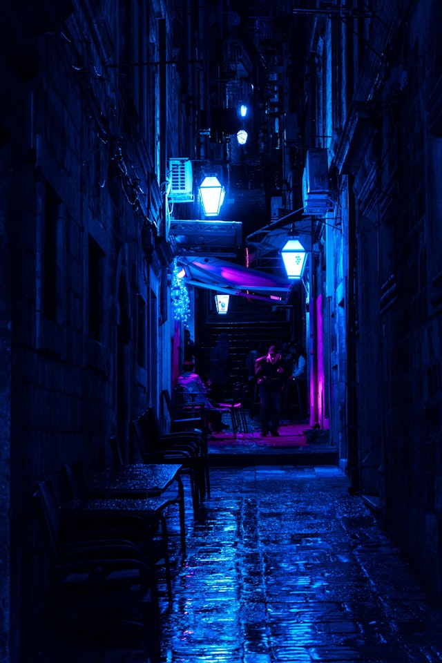 Dark Alley With Turned-on Street Lamps