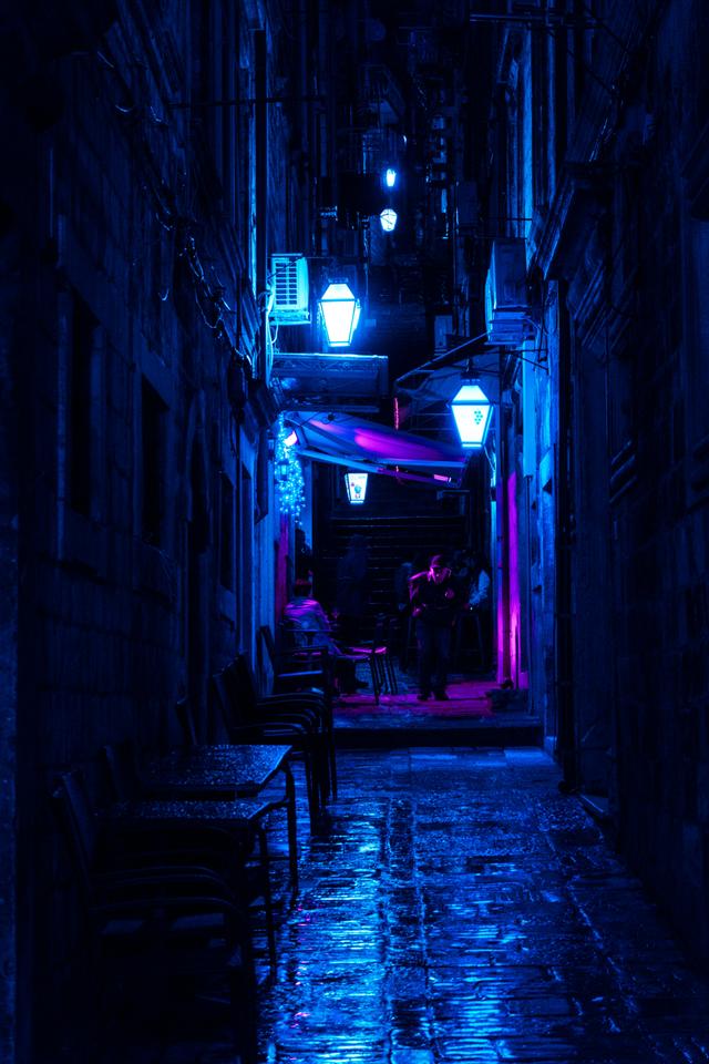 Dark Alley With Turned-on Street Lamps